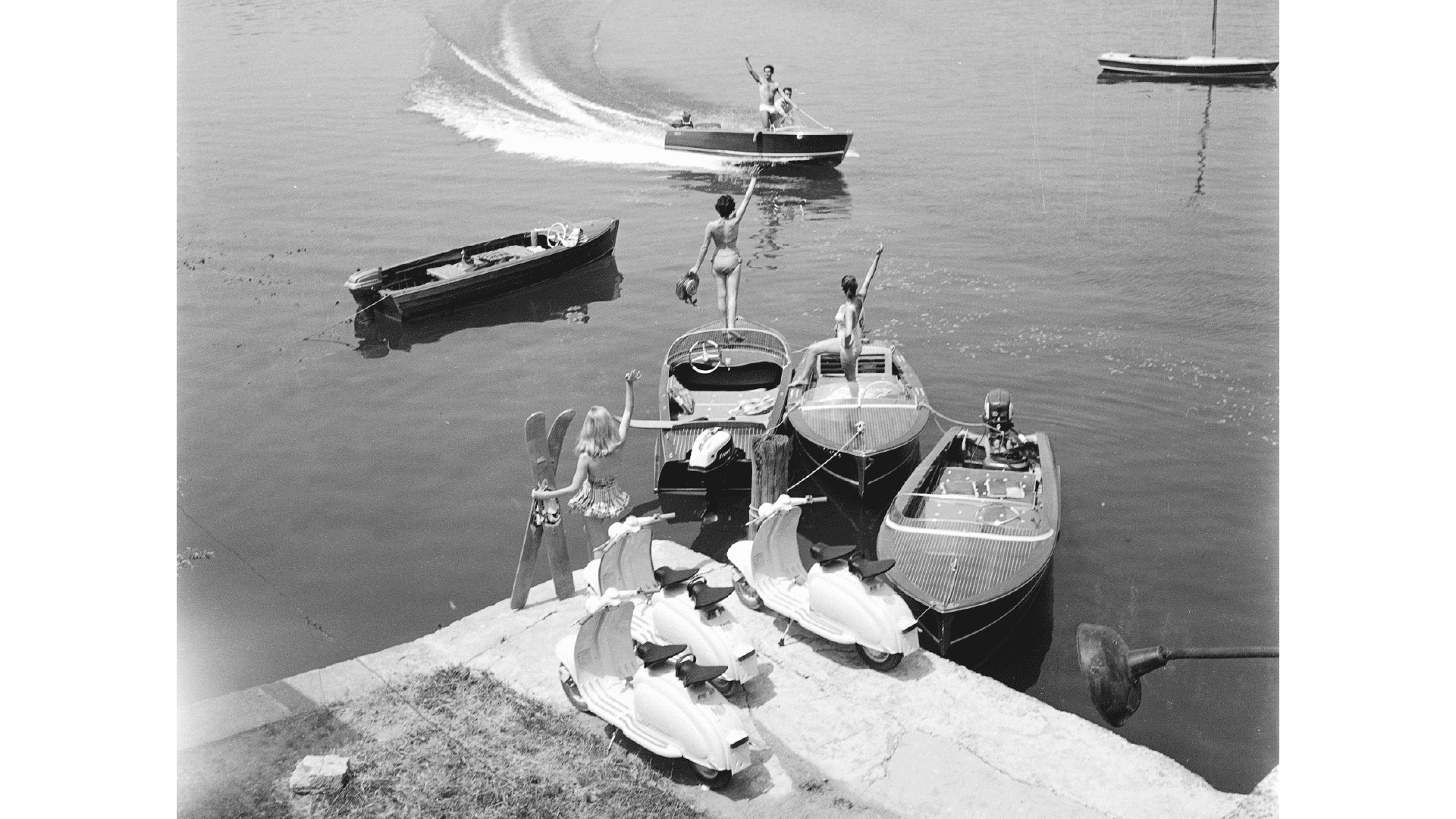 3 Lambretta Scooters stationary by a harbour